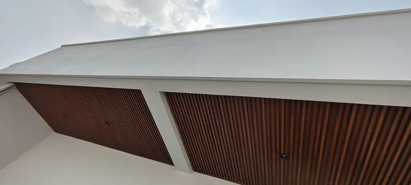 Wood-effect slatted ceiling panels on a building exterior soffit