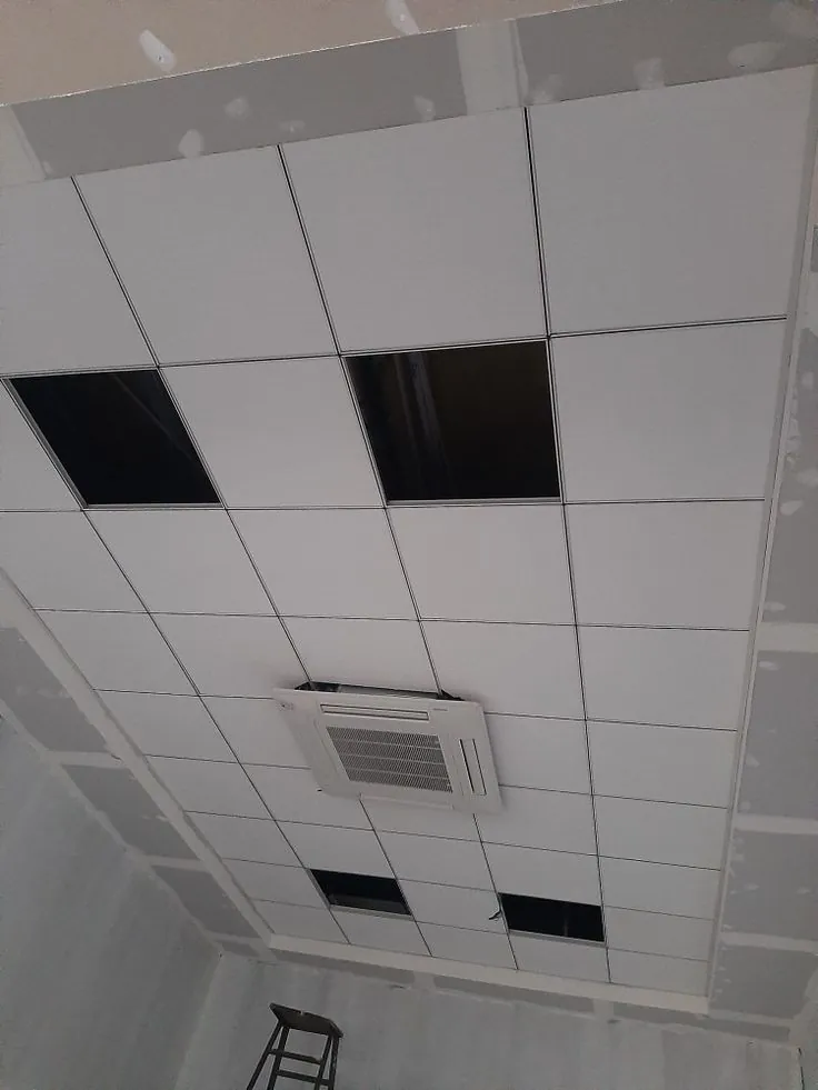 2×2 grid ceiling with an AC cassette unit and a few open tile spaces