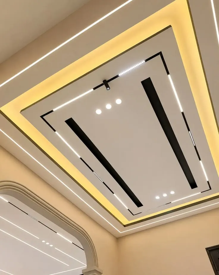 Gypsum ceiling with layered cove lighting, black inlay strips and white LED lines
