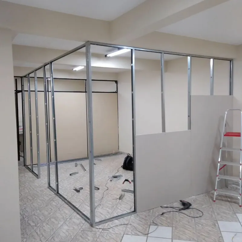 Metal frame and gypsum board partition during installation in an office space