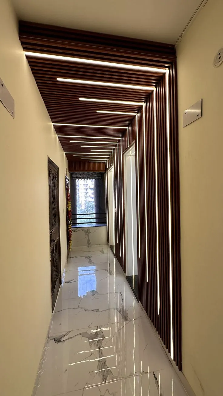 Corridor with wood-effect slatted ceiling and white LED light lines