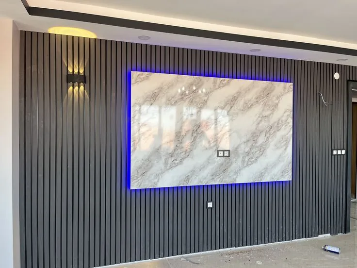 Dark fluted wall panels with a marble-effect panel and blue LED edge lighting