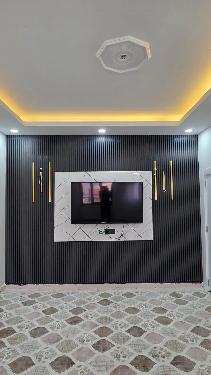 Dark fluted TV wall with a marble-effect panel and gold accent strips